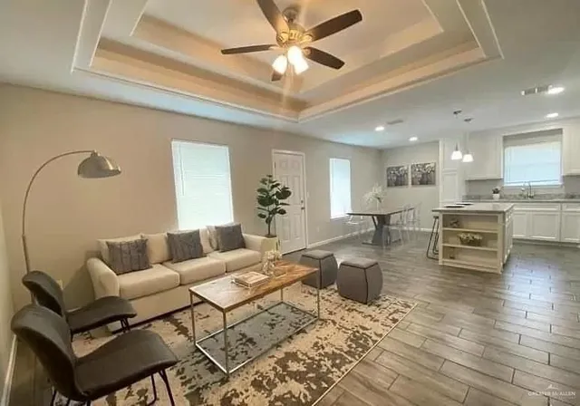 a living room with furniture and kitchen view