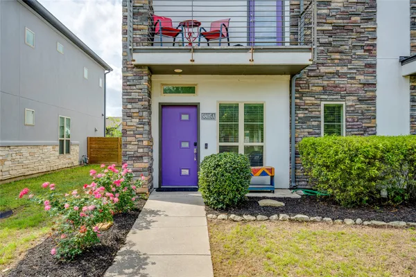 a front view of a house with plants