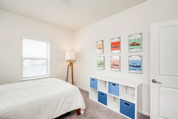 a bedroom with a bed and window