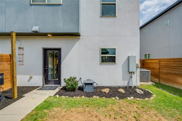 a view of a house with potted plants