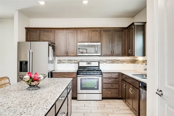 a kitchen with sink cabinets and wooden floor