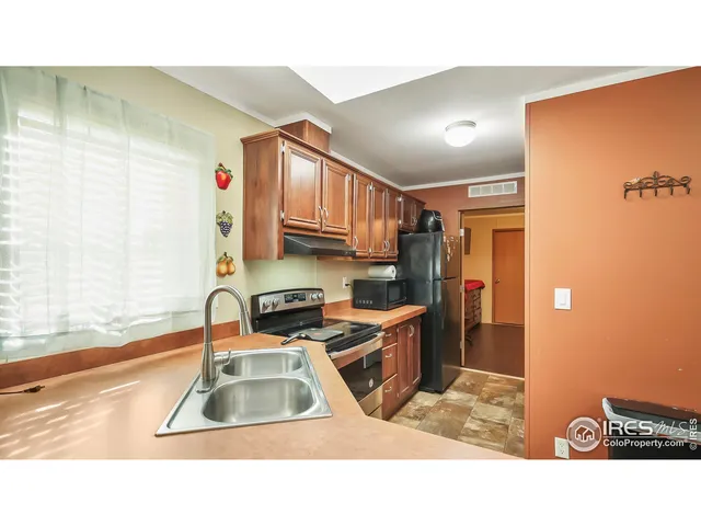 a kitchen with a sink a stove and a refrigerator
