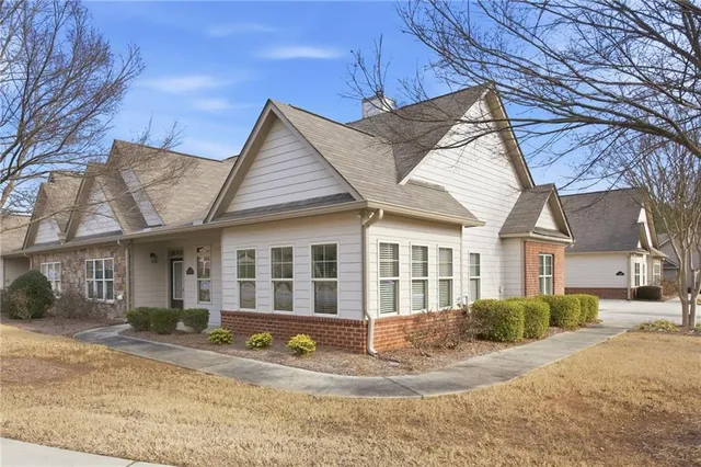 a view of a house with a yard and sitting area
