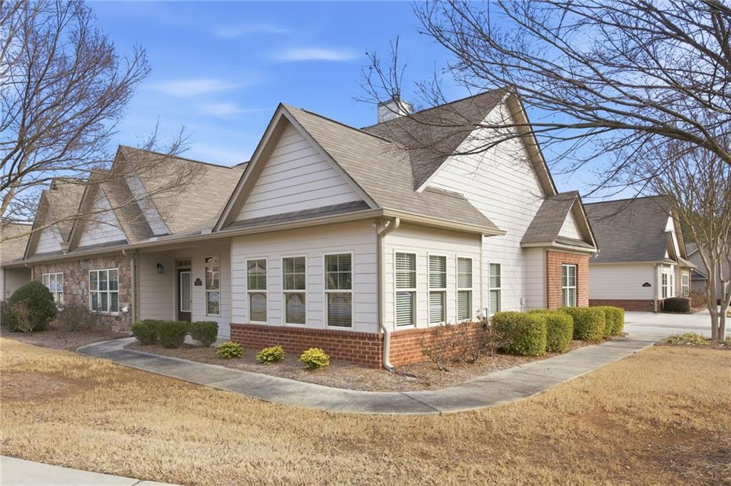 a view of a house with a yard and sitting area