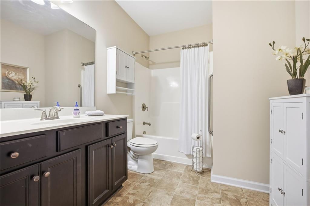 2403 Tree Arbor Way Marietta, GA 30064 - Photo 23 of 25 a bathroom with a sink toilet a mirror and shower