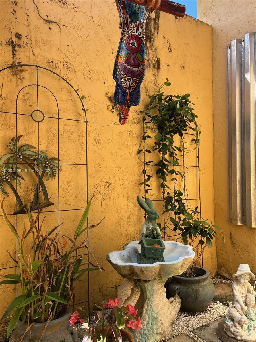 6061 Southwest 128th Court Miami, FL 33183 - Photo 15 of 16 a table with a vase and flowers on it