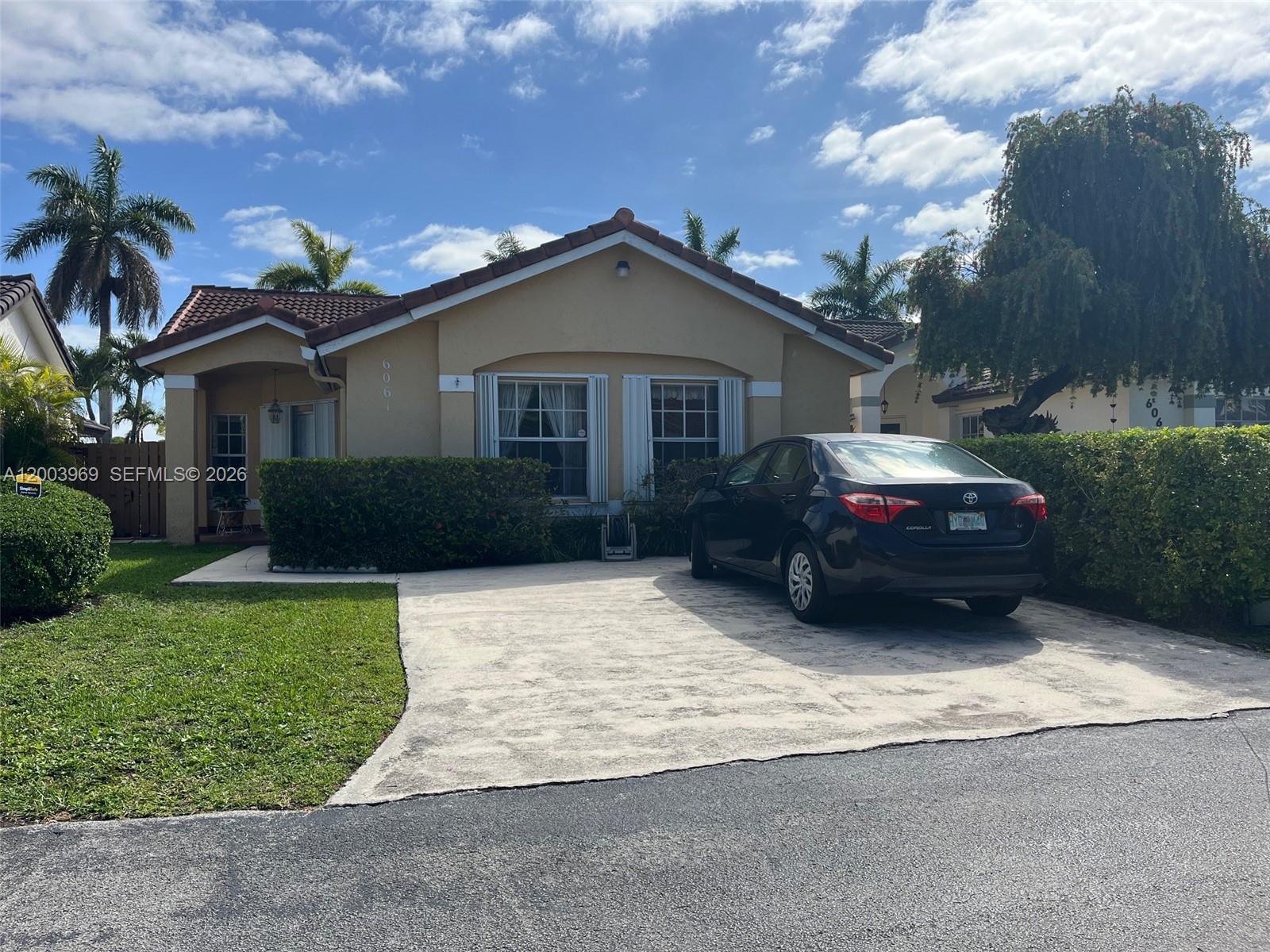 6061 Southwest 128th Court Miami, FL 33183 - Photo 2 of 16 a house view with a garden space