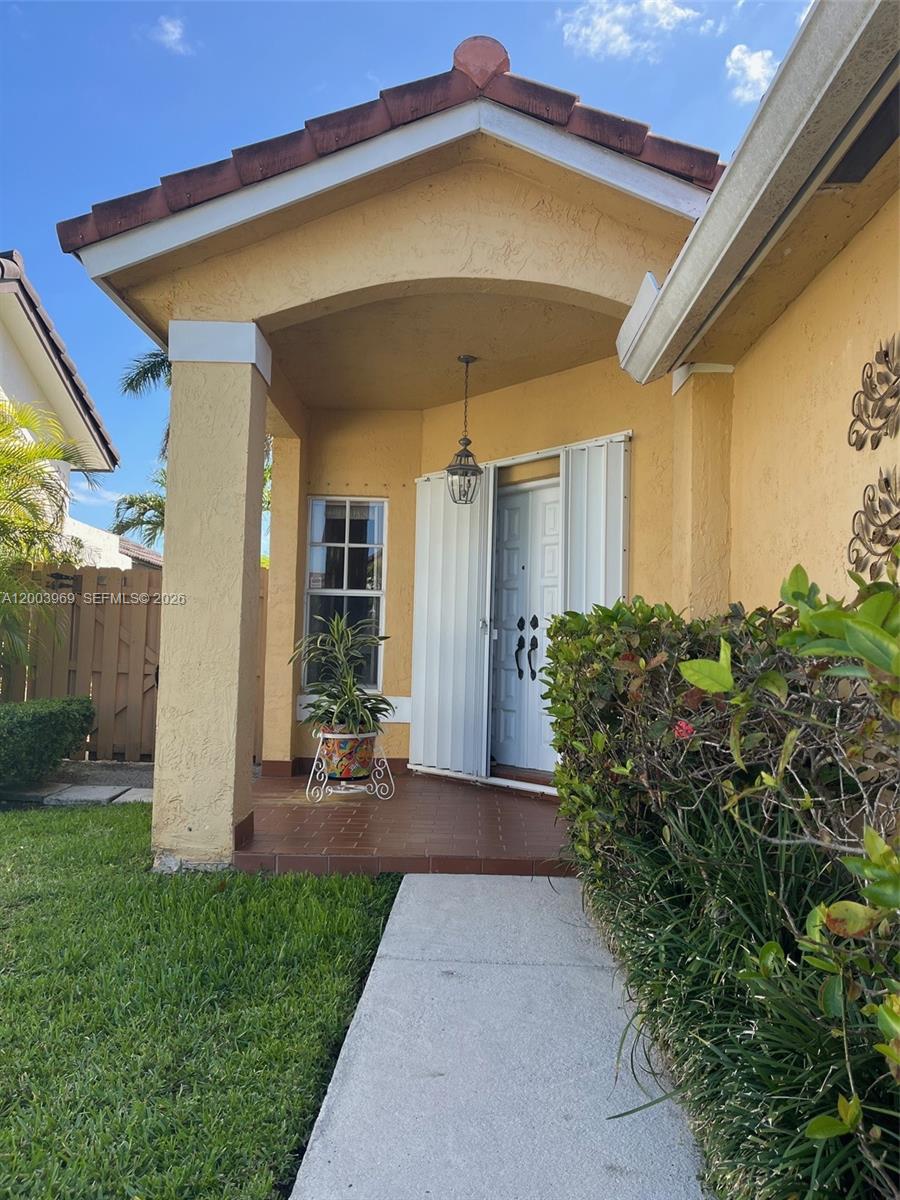 6061 Southwest 128th Court Miami, FL 33183 - Photo 3 of 16 a front view of a house with garden