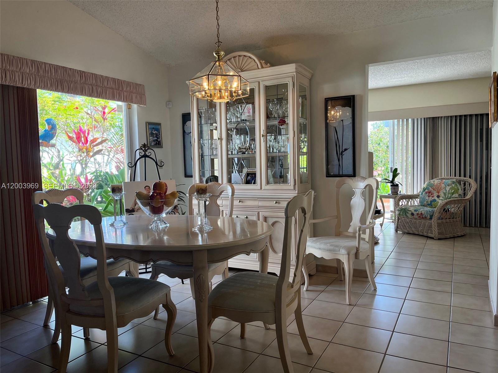 6061 Southwest 128th Court Miami, FL 33183 - Photo 5 of 16 a view of a dining room with furniture large windows and wooden floor