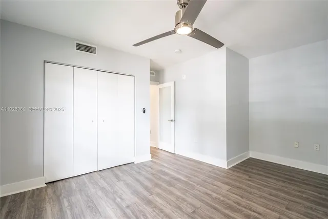 an empty room with wooden floor