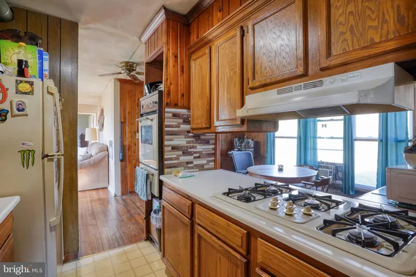 a kitchen with a stove and a refrigerator
