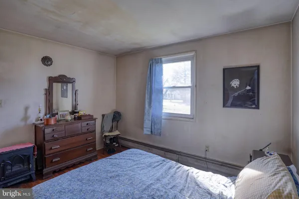 a bed room with a bed and a window