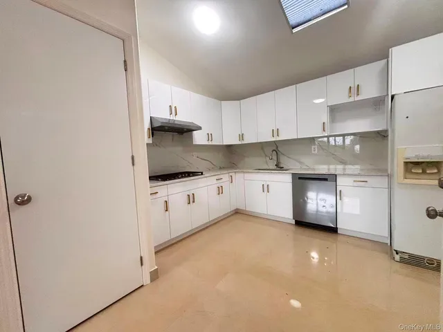 a kitchen with stainless steel appliances a refrigerator sink and cabinets