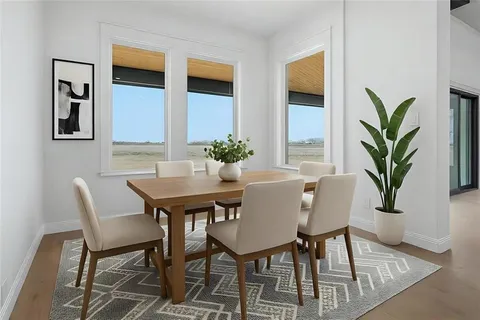 a view of a dining room with furniture and window