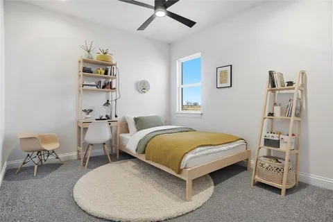 a bedroom with a bed and a chair