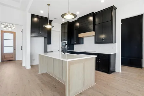 a kitchen with a refrigerator and a sink