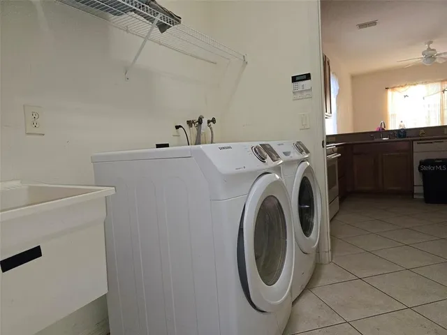 a kitchen with stainless steel appliances granite countertop a refrigerator and a stove