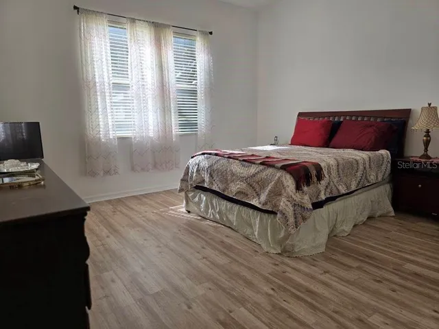 a bedroom with a bed and a mirror