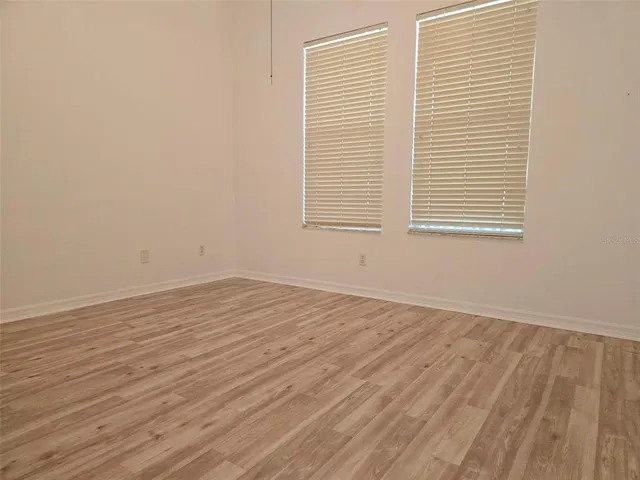 a bathroom with a granite countertop sink a toilet and mirror
