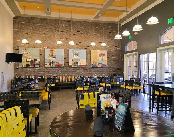 a living room with lots of furniture and chandelier