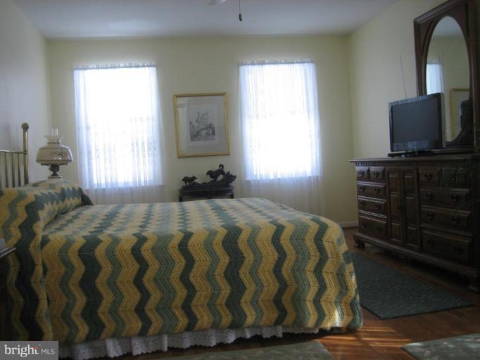6542 Little Ox Road Fairfax Station, VA 22039 - Photo 10 of 30 a bedroom with a bed and a flat tv screen on dresser