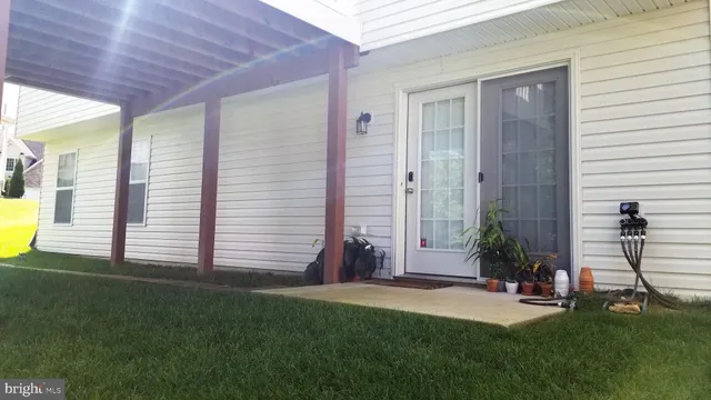 a porch with a table and chairs