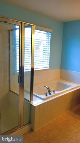 a bathroom with bathtub and window