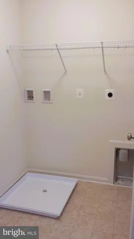 a bathroom with a shower and white bath tub