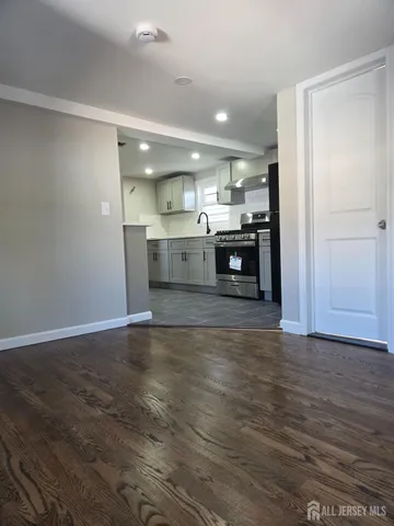 a view of a kitchen with a sink and a stove top oven