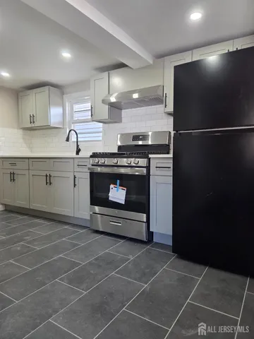 a kitchen with a sink stainless steel appliances and cabinets