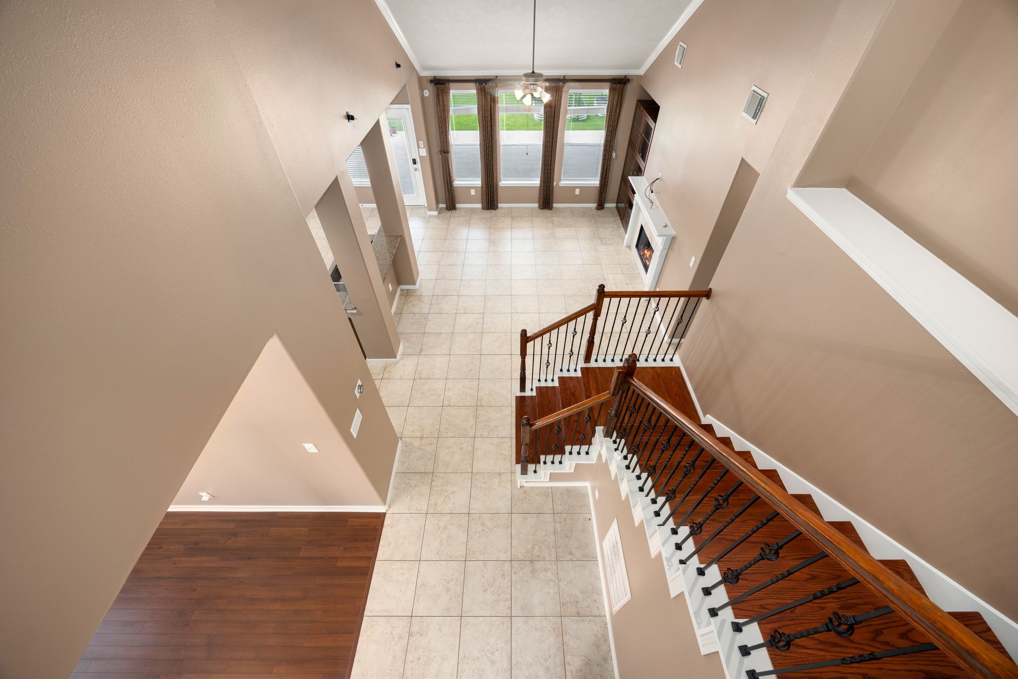4526 Countrypines Drive Spring, TX 77388 - Photo 38 of 38 This impressive upstairs view provides an excellent look at the home’s functional floor plan. Watch how the rich wood-tread staircase overlooks the expansive tile flooring below, seamlessly connecting the main living areas, the kitchen breakfast bar, and the formal dining space.