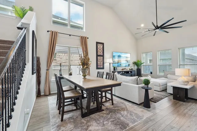 a living room with furniture a fireplace and a chandelier