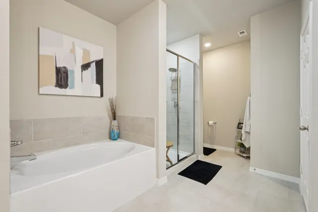 a spacious bathroom with a bathtub and a shower