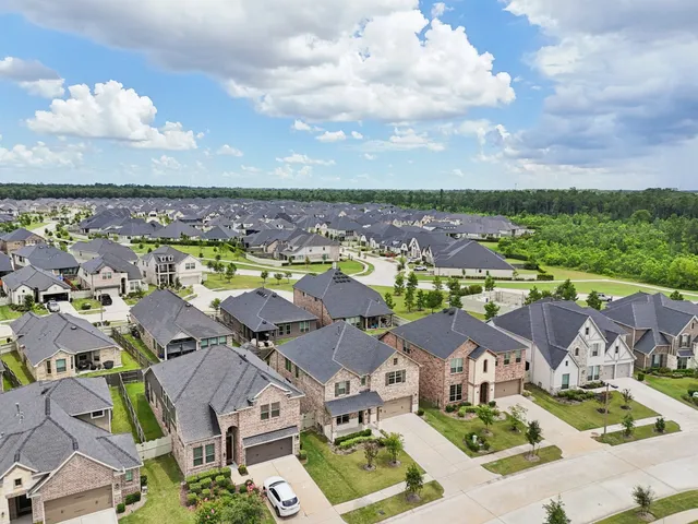 an aerial view of residential houses with outdoor space