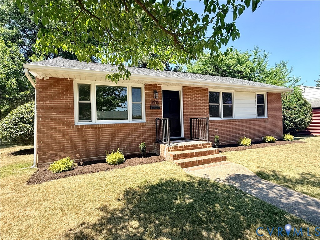 Brick exterior featuring white trim and a contrast