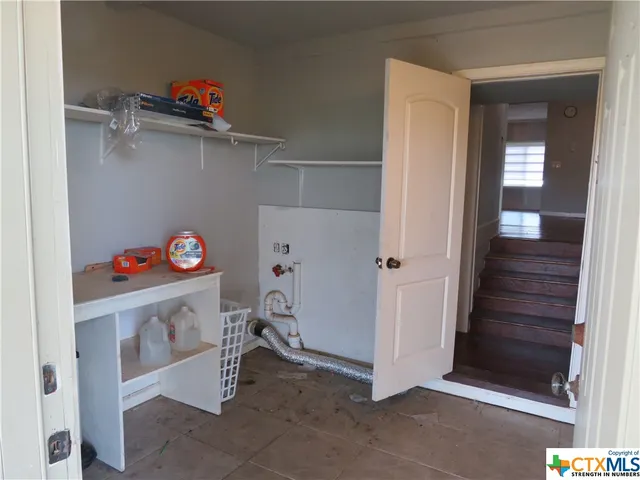 a view of storage and utility room with closet