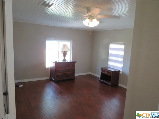 a view of a livingroom with furniture wooden floor and a window
