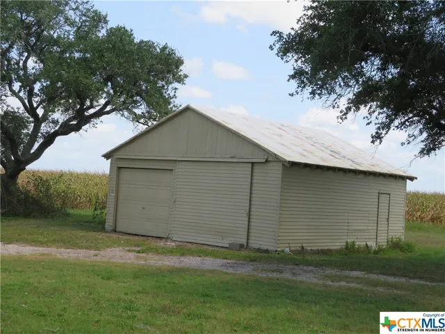 a front view of house with yard and trees