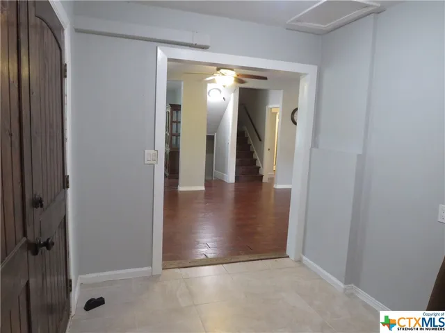 a view of a hallway with wooden floor