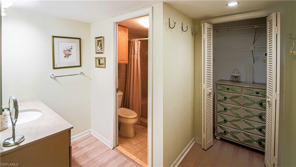 67 Pebble Beach Boulevard Naples, FL 34113 - Photo 18 of 28 Bathroom with toilet, baseboards, a closet, and wood finished floors