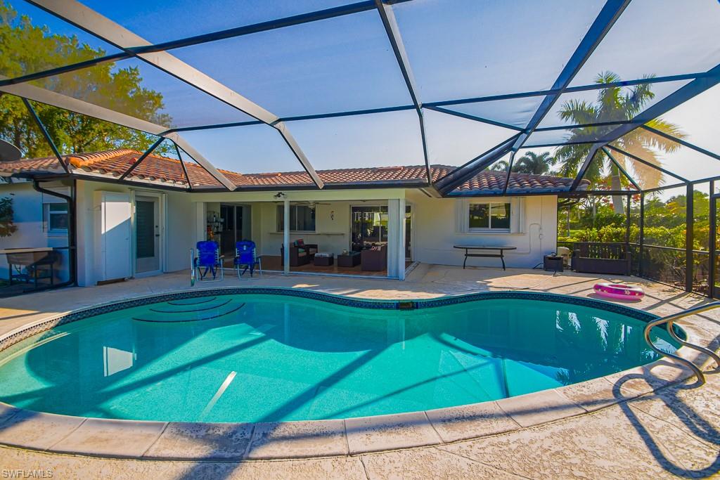 67 Pebble Beach Boulevard Naples, FL 34113 - Photo 23 of 28 Outdoor pool with a lanai and a patio area