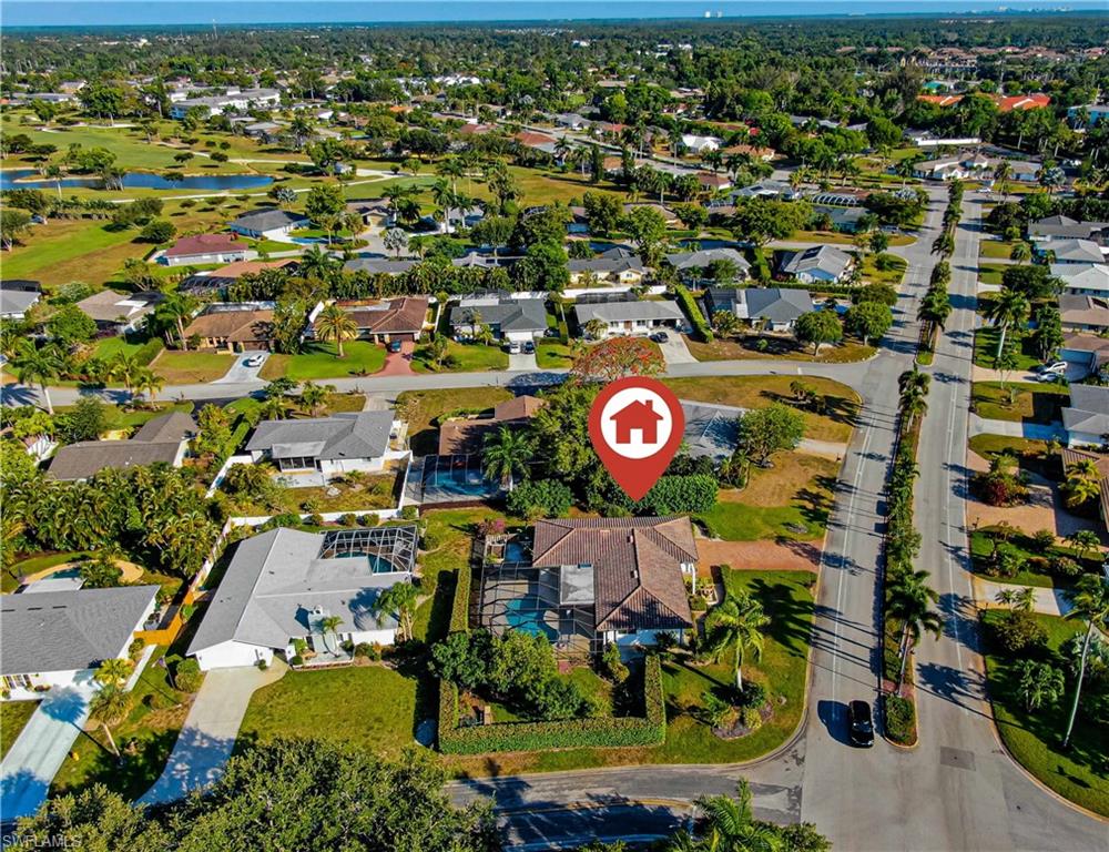 67 Pebble Beach Boulevard Naples, FL 34113 - Photo 27 of 28 Aerial view with a water view and a residential view