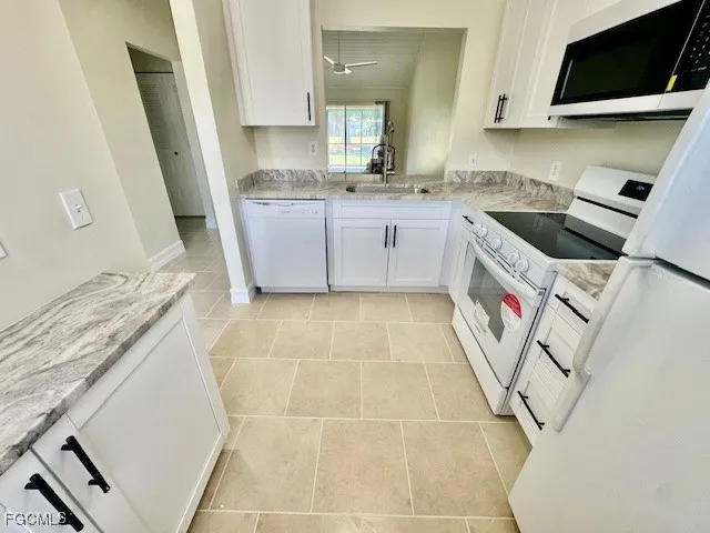 a kitchen with a sink a window and stainless steel appliances