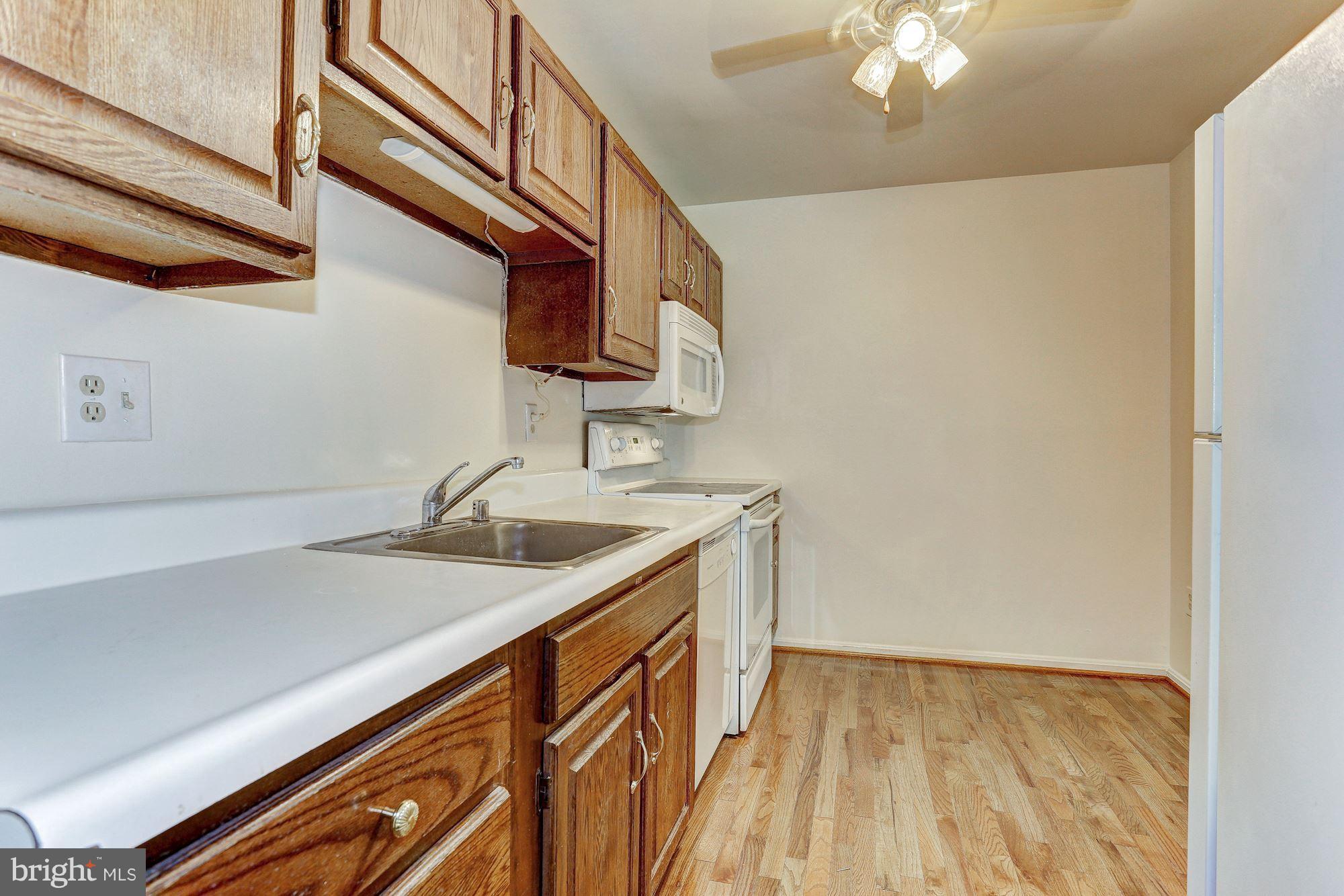 9776 Whiskey Run Laurel, MD 20723 - Photo 7 of 15 a kitchen with a sink and cabinets