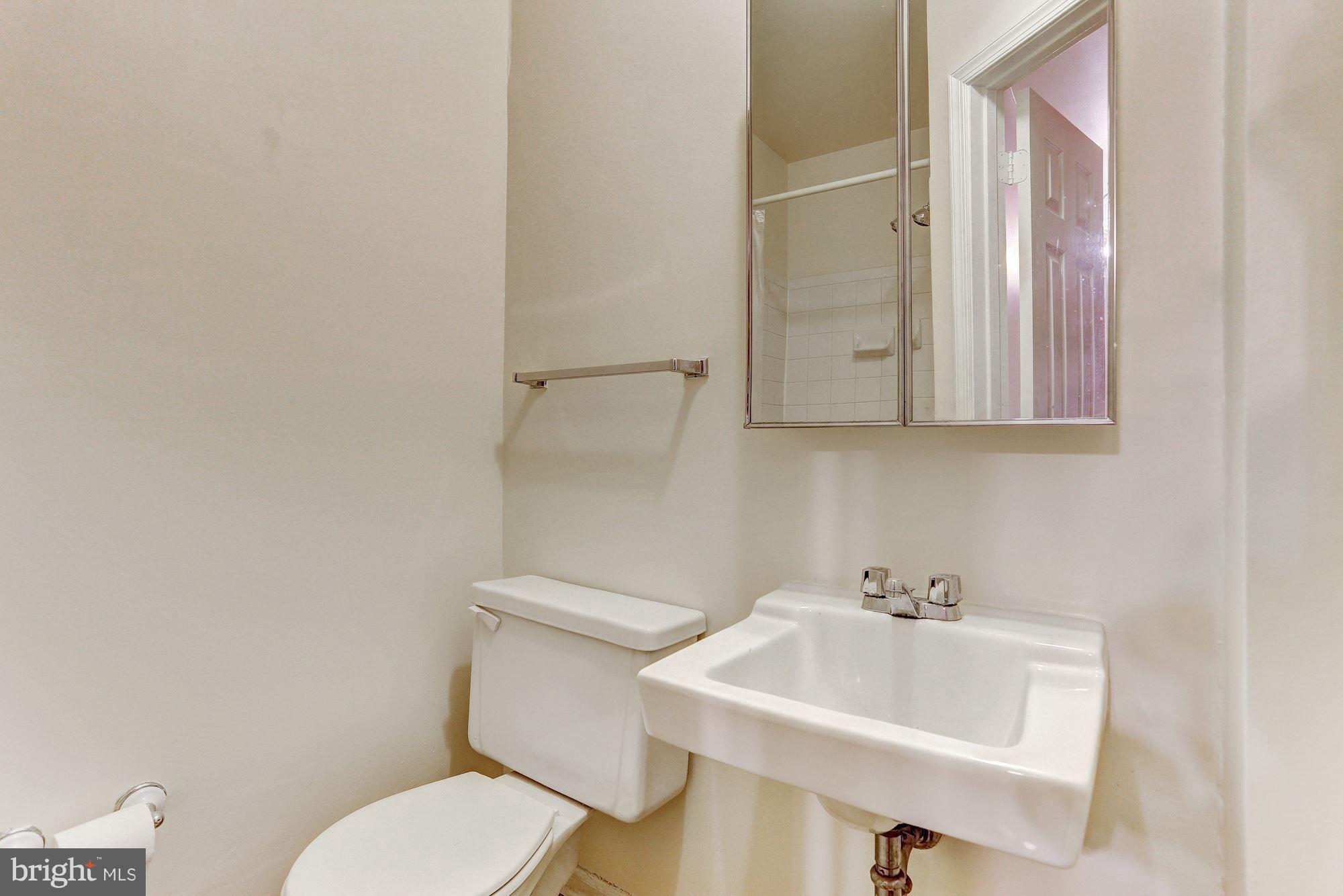 9776 Whiskey Run Laurel, MD 20723 - Photo 8 of 15 a bathroom with a sink a toilet and mirror