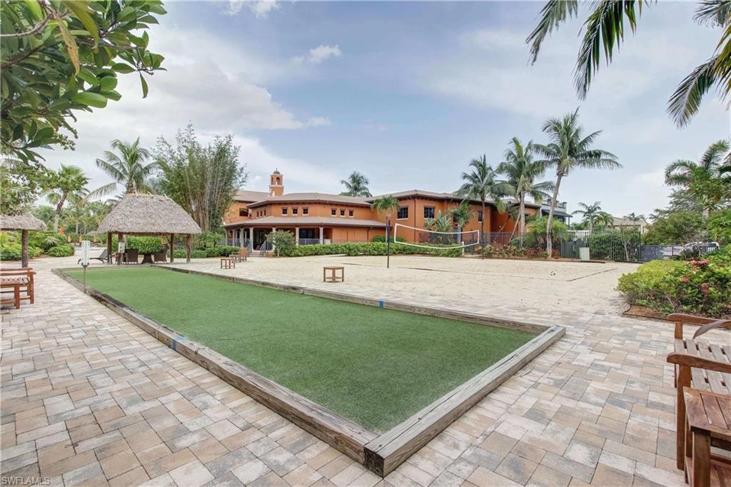 9076 Rialto Street, Unit 6204 Naples, FL 34113 - Photo 47 of 50 Outdoor recreational space featuring a bocce ball court with artificial turf surface, a sand volleyball court, and a thatched-roof cabana