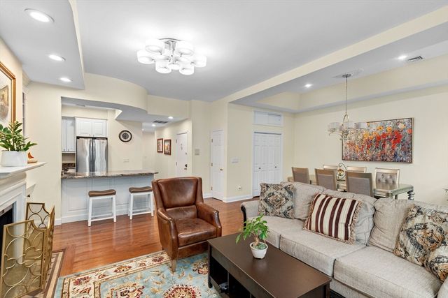 a living room with furniture and a chandelier