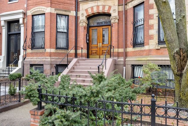 a view of a brick building next to a yard