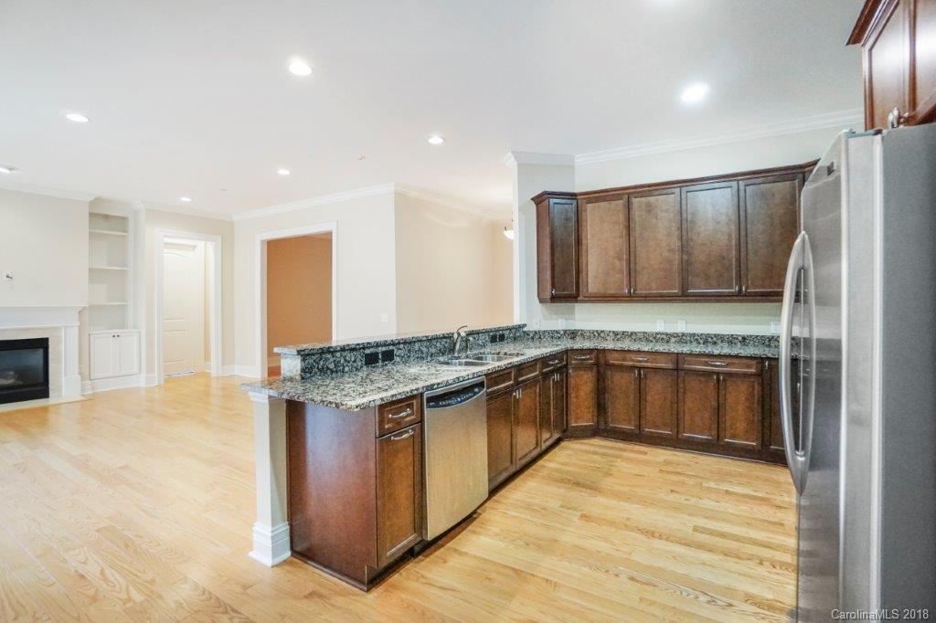 3272 Park Road Charlotte, NC 28209 - Photo 12 of 31 a kitchen with stainless steel appliances granite countertop a stove and a refrigerator