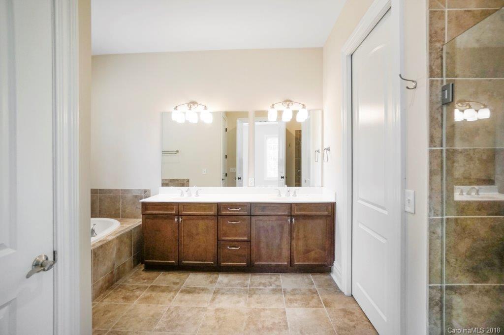 3272 Park Road Charlotte, NC 28209 - Photo 15 of 31 a spacious bathroom with a double vanity sink a mirror and a shower